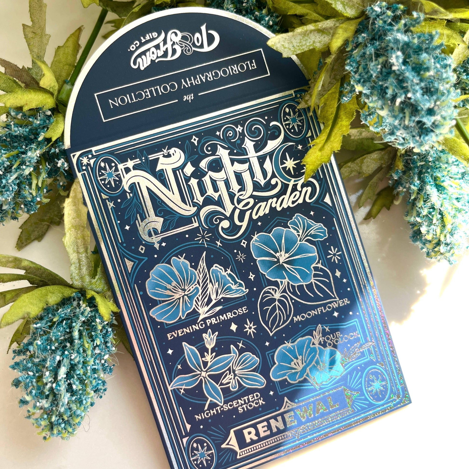 Pack of 'Nightly Garden' flowers seeds with decorative packaging on a floral background