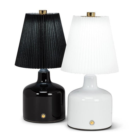 Black and white table lamps with pleated shades on a white background