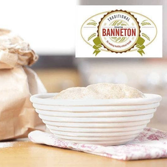 Banneton proofing basket with a bag of flour on a wooden surface, featuring the Banneton logo.